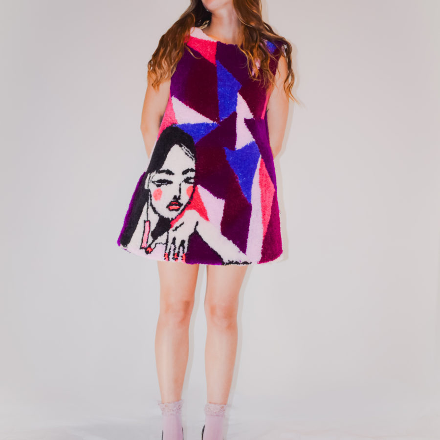 The Manta Dress was constructed primarily by a tufting gun and punch needling. I was inspired to create a mini dress that is feminine and rich in texture, meant to be a playful and interactive.    “Manta” means a rough-textured fabric or blanket made and used in Spanish America and the southwest United States. The name is a nod to my ancestry.