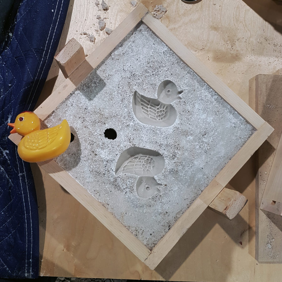 open sand mould of rubber ducky