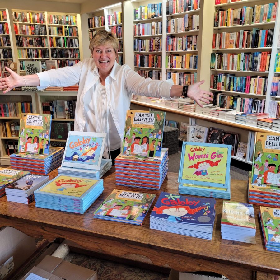 Joyce Grant with a table displaying her books