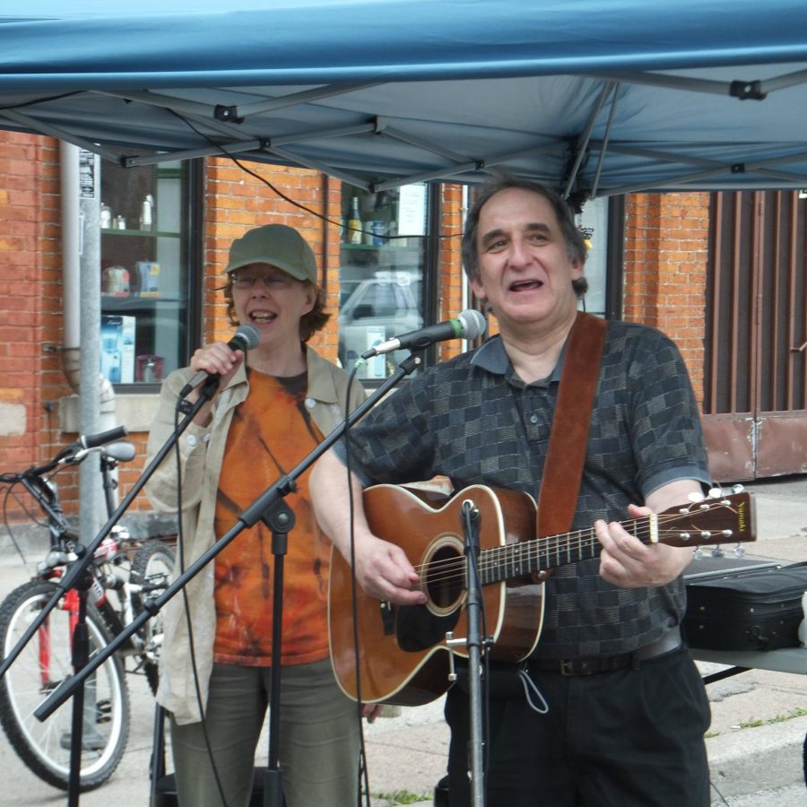 Ron Weihs and Judith Sandiford playing guitar and autoharp at Open Streets 