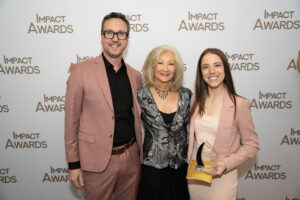 David Hudson, Connie Smith, Megan Divecha, holding award.