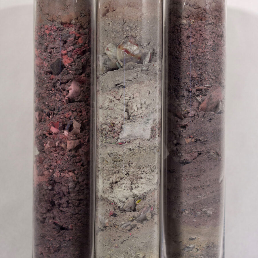 Tall glass tubes of dust remnants from the production of the Transmute III animation. Glass samples are 30cm x 46cm x 12cm, part of the Transmute series from 2022 - 2024