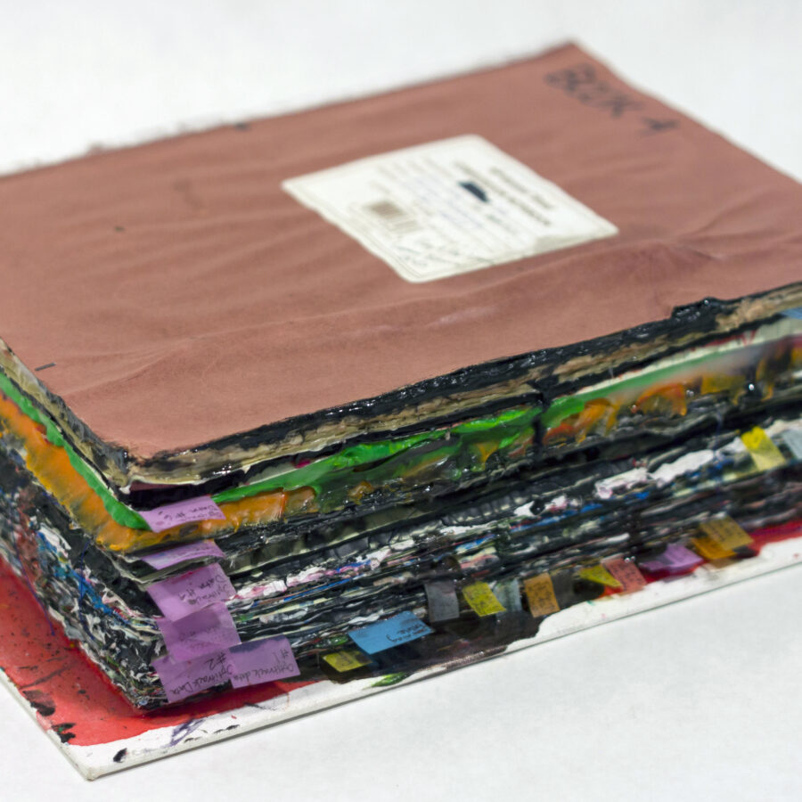 A laboratory notebook with materials layered into the pages, resulting in an expanded block of book-like material. The block is 23.5cm x 30cm x 10cm and ready to be sanded and filmed to create the final animation in the Transmute series, 2022 - ongoing