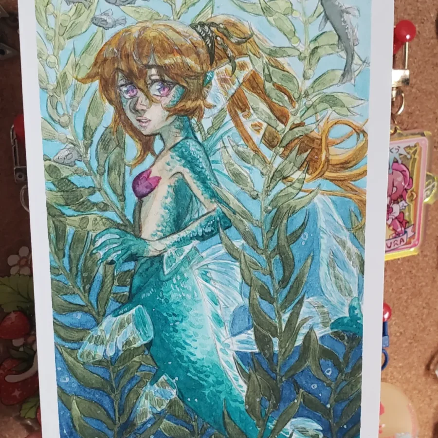 Watercolour illustration of a mermaid in a kelp forest